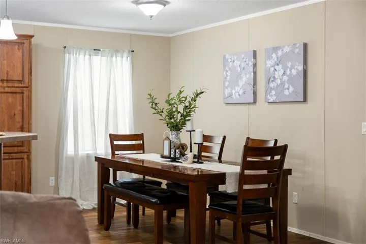 Dining room featuring dark hardwood / wood-style floors and crown molding