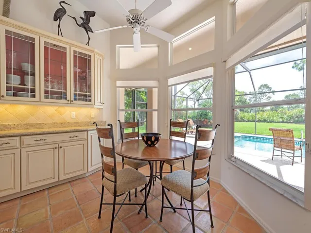 Bright and airy breakfast nook with views of the lanai and yard