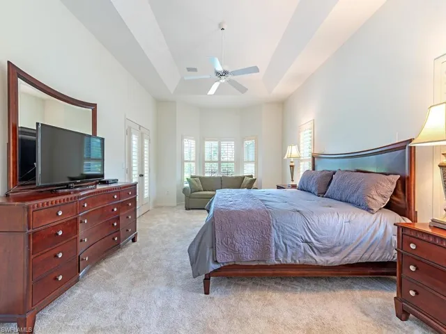 Spacious Primary bedroom with room for a sitting area and views of the lanai and backyard