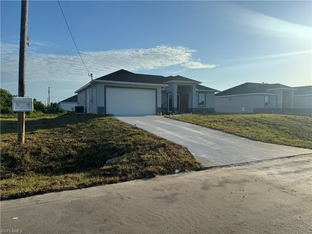 Single story home featuring a front lawn and a garage