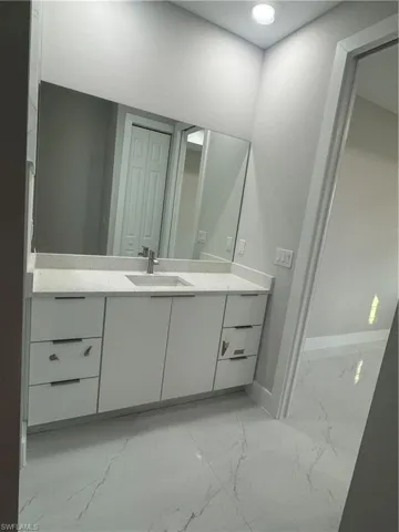 Bathroom with tile flooring and vanity