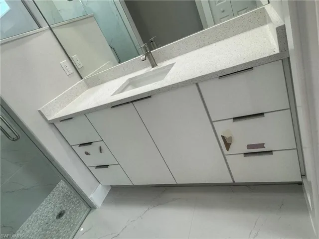 Bathroom featuring tile floors and oversized vanity