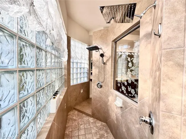Bathroom featuring tile walls and tiled shower