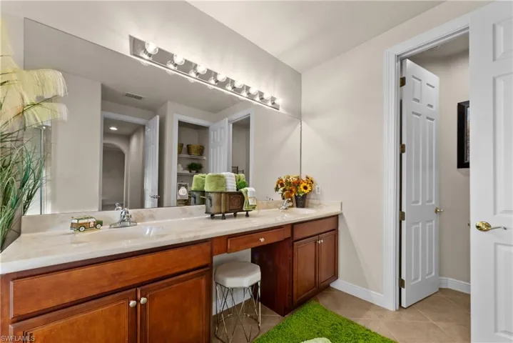 Bathroom featuring tile patterned flooring and vanity