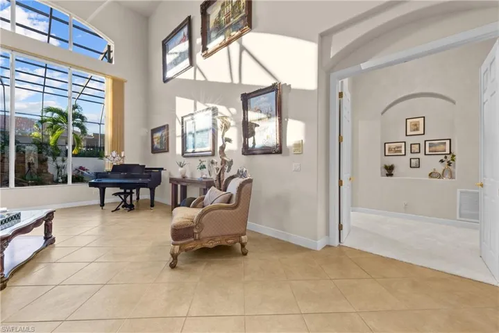 Sitting room featuring a high ceiling and light tile patterned flooring