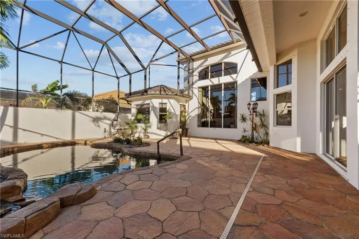 View of patio / terrace with a fenced in pool and glass enclosure