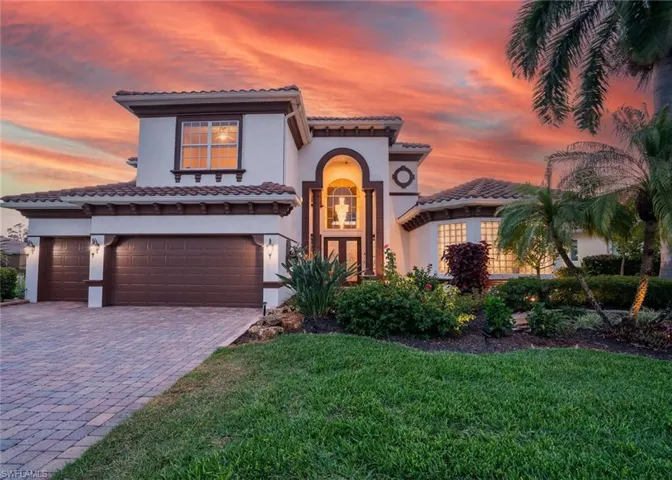 Mediterranean / spanish-style house with a garage and a yard