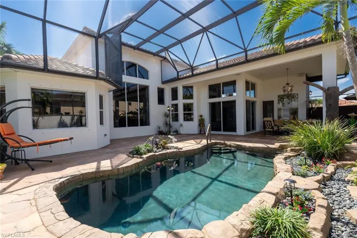 View of pool with a patio area and a lanai