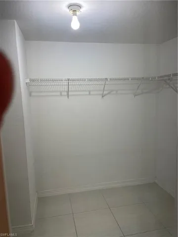 Spacious closet with light tile patterned flooring