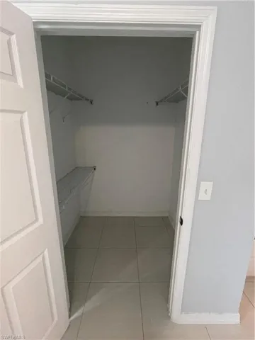 Spacious closet featuring light tile patterned flooring