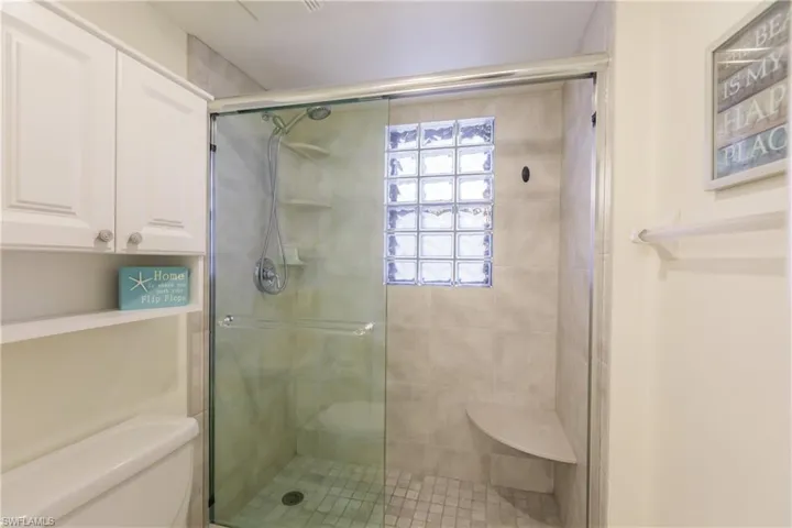 Bathroom with toilet and a shower with shower door
