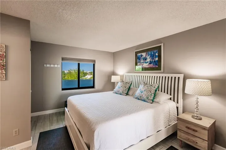 Bedroom featuring hardwood / wood-style floors and a textured ceiling