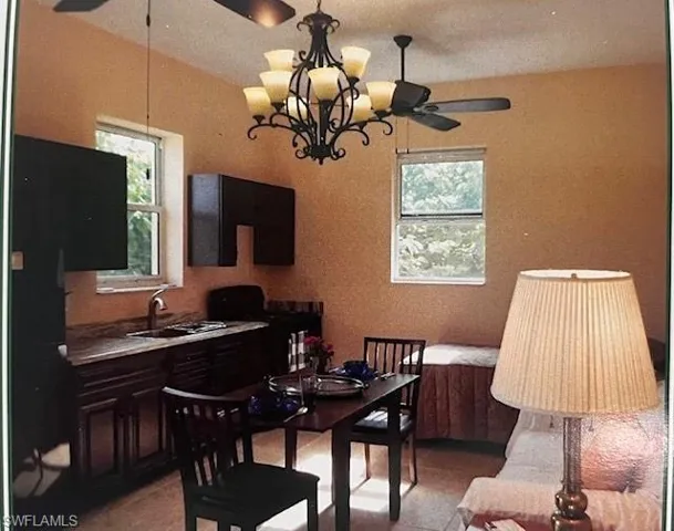 Kitchen area has refrigerator, stove, sink and microwave