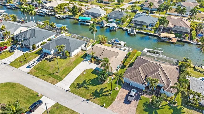 Aerial view of residential area featuring a nearby body of water