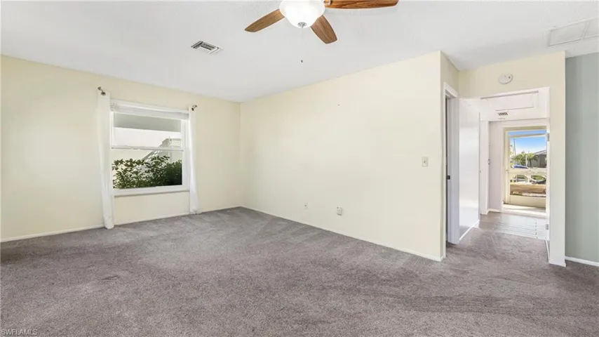 Spare room featuring ceiling fan and carpet flooring