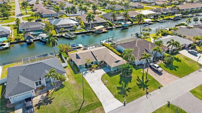 Aerial perspective of suburban area featuring a large body of water