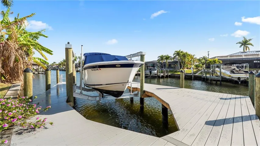 Dock area featuring boat lift and a water view