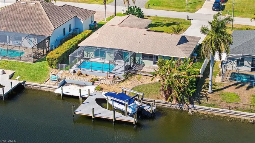 View from above of property with a pool area and a nearby body of water