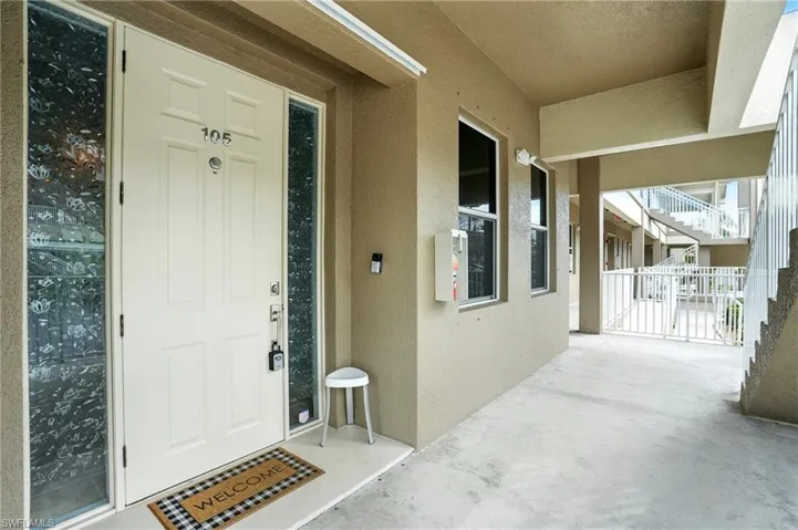 Entrance to property featuring stucco siding