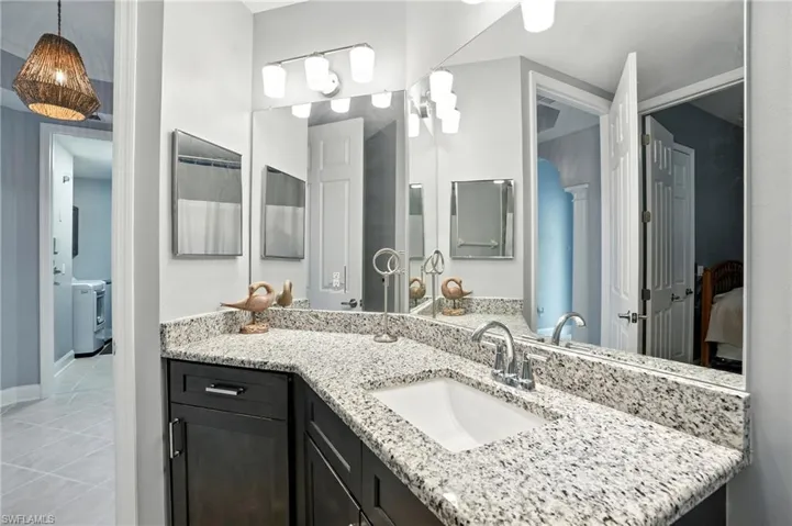Bathroom with vanity and light tile patterned flooring