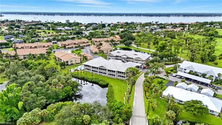 Aerial view of residential area featuring a nearby body of water
