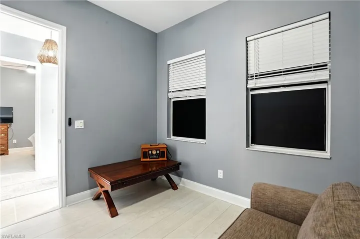 Sitting room featuring baseboards and light wood-style floors