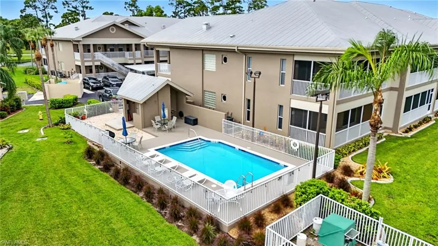 Community pool featuring a patio and a balcony