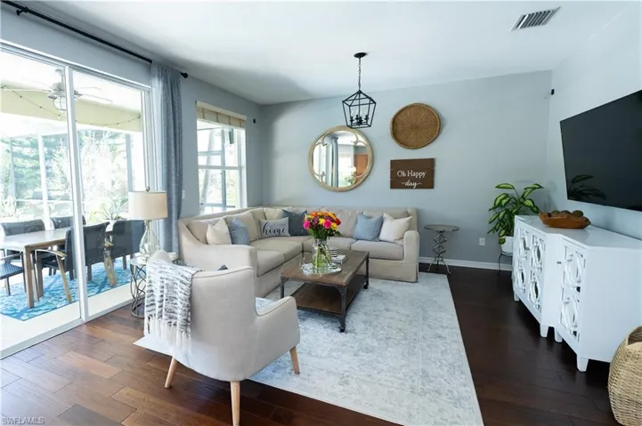 Spacious living area featuring wood-finish flooring and light-toned walls