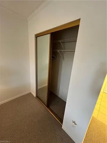 View of closet in primary bedroom.
