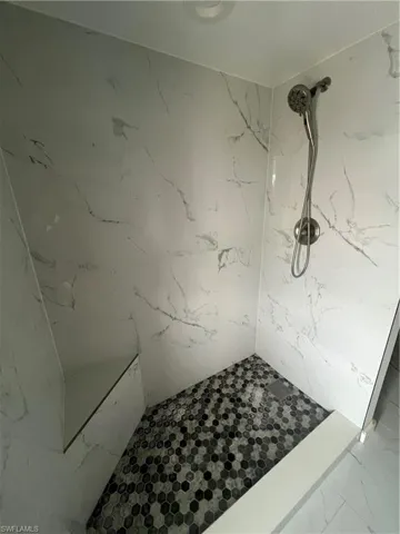Bathroom featuring walk in shower and tile patterned floors