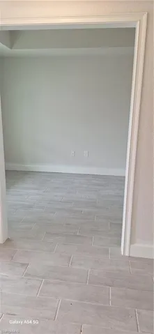 Bathroom featuring a textured wall, vanity, and shower / bathtub combination