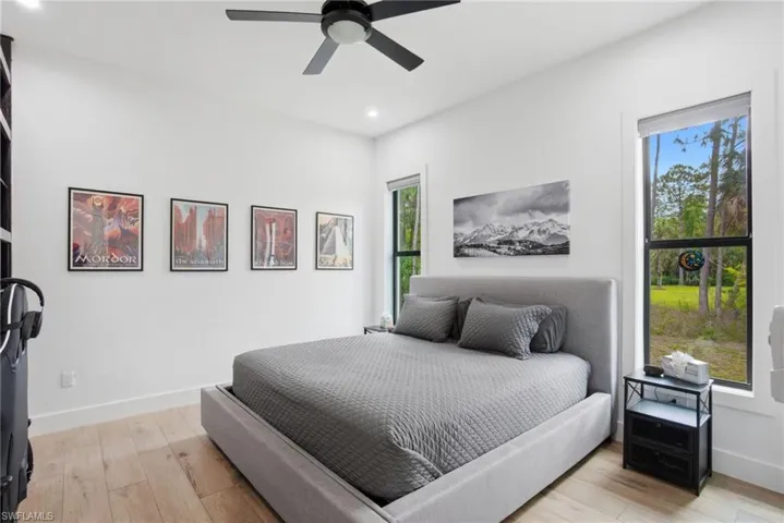 Bedroom featuring wood-finish flooring, recessed lighting, and a contemporary ceiling fan