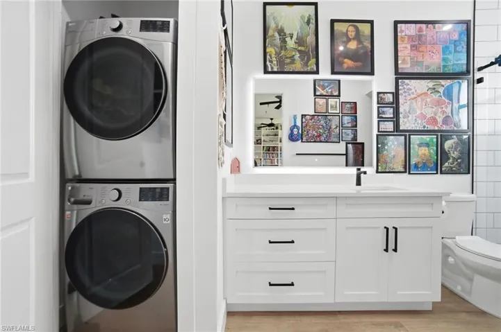 Contemporary bathroom vanity featuring white cabinetry with matte black hardware, a rectangular undermount sink, and a black faucet