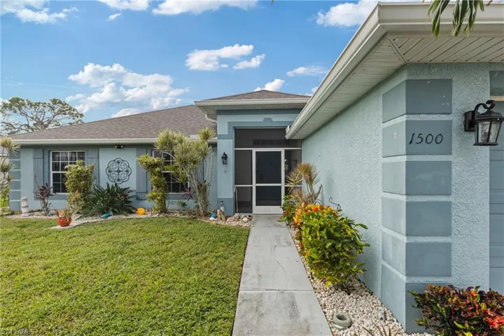 Entrance to property with a lawn