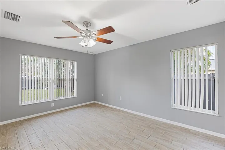 Spare room featuring ceiling fan and light hardwood / wood-style flooring