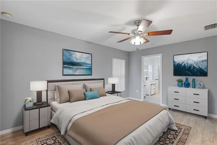 Bedroom featuring light hardwood / wood-style flooring, connected bathroom, and ceiling fan