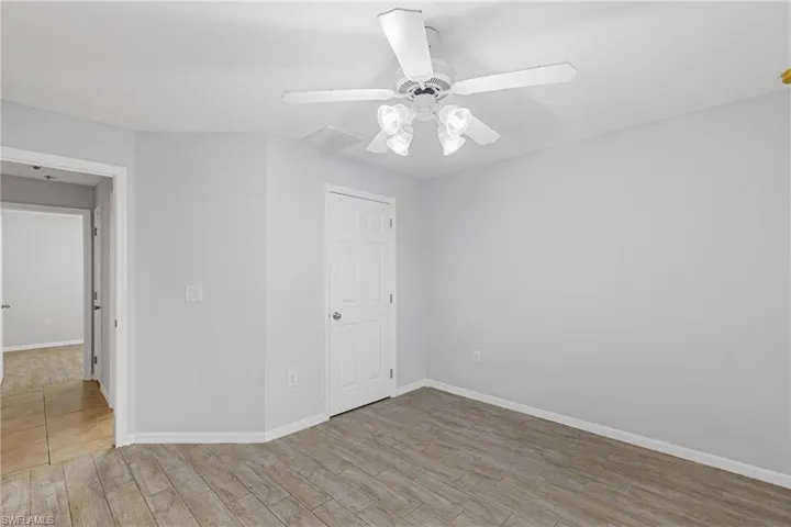 Empty room with light wood-type flooring and ceiling fan