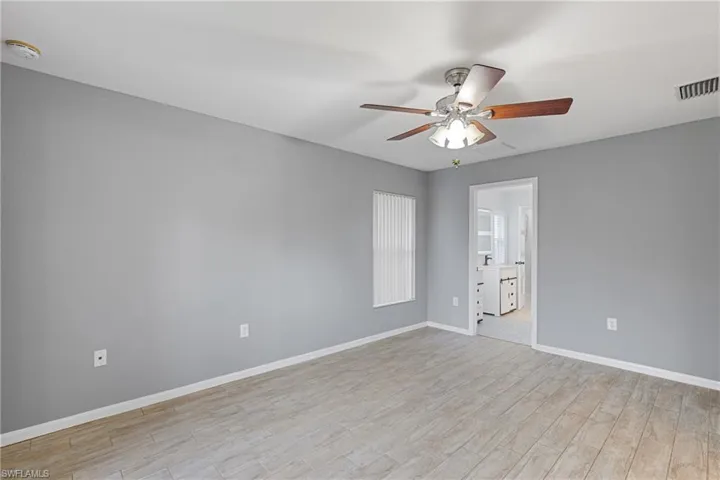 Empty room featuring light hardwood / wood-style flooring and ceiling fan