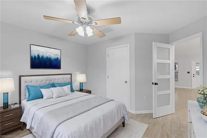 Bedroom featuring light hardwood / wood-style floors and ceiling fan