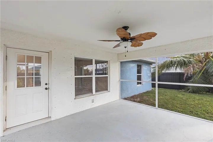 Unfurnished sunroom featuring ceiling fan