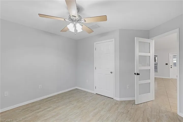Unfurnished bedroom with light wood-type flooring and ceiling fan