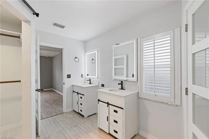Bathroom featuring vanity and hardwood / wood-style floors