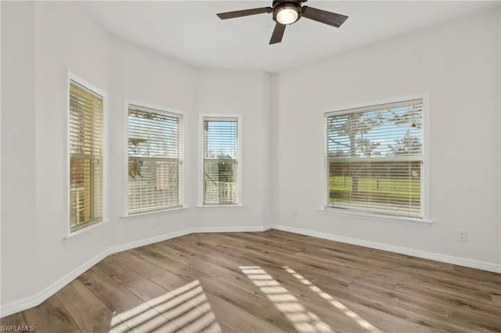 Spare room with ceiling fan and wood-type flooring