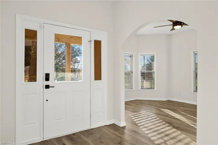 Foyer entrance featuring dark hardwood / wood-style floors and ceiling fan