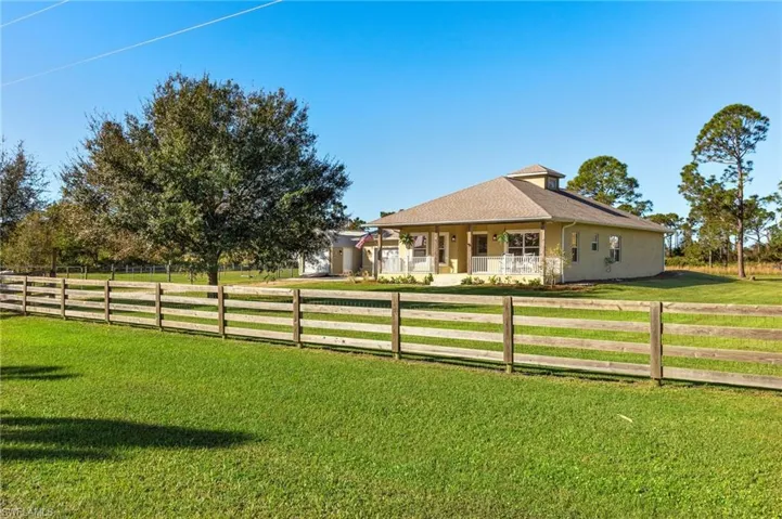 View of yard with a porch and a rural view