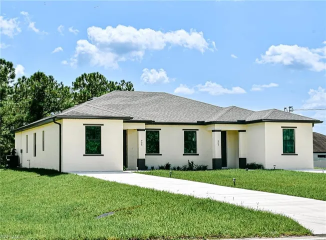 Prairie-style house with stucco siding and a front lawn