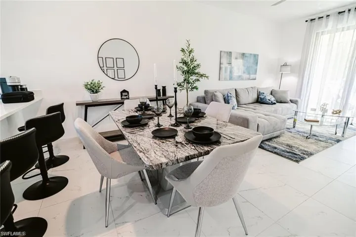 Dining space with light marble finish floors