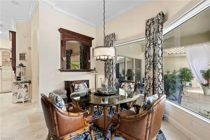 Dining room featuring crown molding and light tile patterned flooring