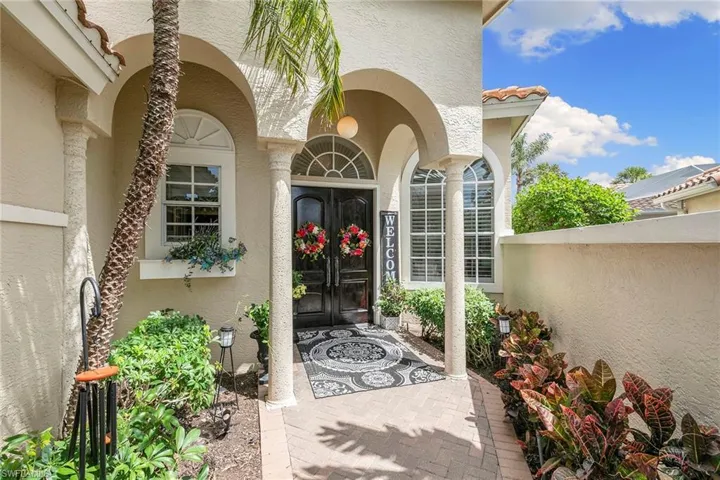 View of exterior entry with stucco siding and french doors