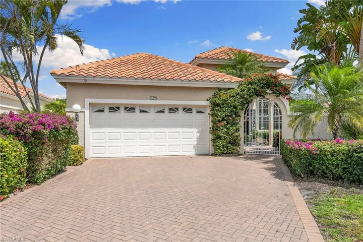 Mediterranean / spanish-style house featuring decorative driveway, stucco siding, a tiled roof, and an attached garage